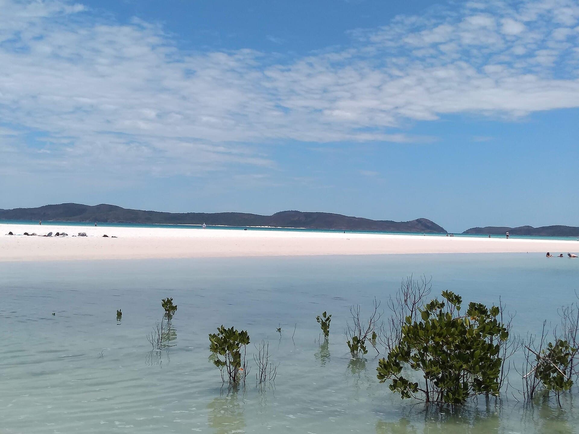 Long Australian beach with turquoise water and pale sand